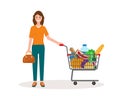 Woman with shopping cart full of food Royalty Free Stock Photo