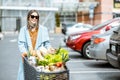 Woman with shopping cart full of food outdooors Royalty Free Stock Photo