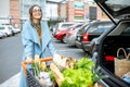 Woman with shopping cart full of food outdooors Royalty Free Stock Photo