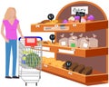 Lady looking at bakery in hypermarket. Woman with shopping cart chooses pastries at grocery store Royalty Free Stock Photo