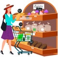 Lady looking at bakery in hypermarket. Woman with shopping cart chooses pastries at grocery store Royalty Free Stock Photo