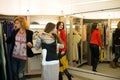 Woman shopping choosing dresses looking in mirror uncertain