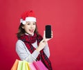 Woman shopping for christmas gifts by smart phone Royalty Free Stock Photo