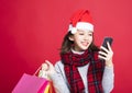 Woman shopping for christmas gifts by smart phone Royalty Free Stock Photo