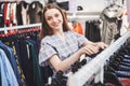 Woman shopping clothes. Shopper looking at clothing indoors in store. Beautiful happy smiling asian caucasian female Royalty Free Stock Photo