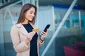 Woman shopping with credit card. Beautiful young lady with gold card using phone