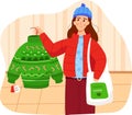 Woman shopping for festive green sweater, finding holiday sale. Cheerful shopper with winter hat holds a quilted bag