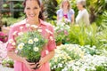 Woman shopping for flowers at garden centre