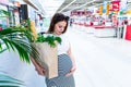 Woman shopping food grocery. Pregnant woman with healthy green vegetables, fresh tomato in market food bag on grocery Royalty Free Stock Photo