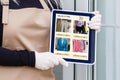 Woman shopping food online using a digital tablet at the kitchen, close-up view on a tablet screen. Concept of buying Royalty Free Stock Photo