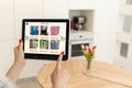 Woman shopping food online using a digital tablet at the kitchen, close-up view on a tablet screen. Concept of buying Royalty Free Stock Photo