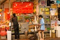 A woman shopping at fruit stall opened to the street at the markets of Western Hong Kong