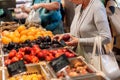 Woman shopping for fruits and vegetables in produce department of a grocery store/supermarket. Royalty Free Stock Photo