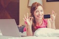 Woman shopping on line holding showing credit card giving ok sign. Royalty Free Stock Photo