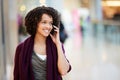 Woman In Shopping Mall Using Mobile Phone Royalty Free Stock Photo