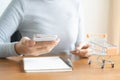 Woman shopping online in cart. Business woman hand using smart phone, payments and holding credit card online shopping Royalty Free Stock Photo