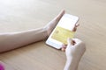 A woman shopping online on her table at home with a smartphone using a gold credit card. And use your credit card to tap the Royalty Free Stock Photo