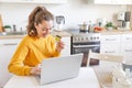 Woman shopping online and paying with gold credit card. Young girl sitting with laptop buying on Internet enter credit Royalty Free Stock Photo