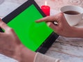 Woman is shopping online with tablet pc empty green screen