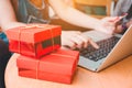 Woman shopping online using laptop with credit card and red gift Royalty Free Stock Photo