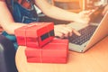 Woman shopping online using laptop with credit card and red gift Royalty Free Stock Photo