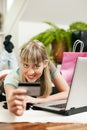 Woman shopping online via Internet from home Royalty Free Stock Photo