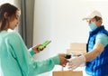 Woman shopping order online from smartphone, receiving packages from delivery man. courier holding paper boxes for