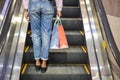 Woman shopping on the scalator in a shopping center