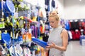 Woman shopping sports equipment in sportswear store. Royalty Free Stock Photo