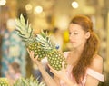 Woman shopping in supermarket, fruit section