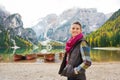 Woman on shores of Lake Bries with wooden boats in background Royalty Free Stock Photo