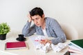 Woman at her desk with laptop and crumpled sheets of paper. Creative crisis, sadness, despair Royalty Free Stock Photo