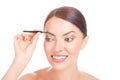 Woman with short hair plucking eyebrows with tweezers Royalty Free Stock Photo