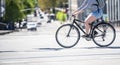 Woman in shorts takes a bike ride deputizing on a city street crossing the intersection Royalty Free Stock Photo