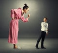 Woman shouting at small scared man