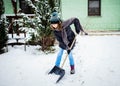 woman with shovel cleaning snow. Winter shoveling. Removing snow after blizzard