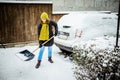 woman with shovel cleaning snow. Winter shoveling. Removing snow after blizzard