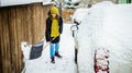 woman with shovel cleaning snow. Winter shoveling. Removing snow after blizzard