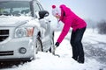 Woman shoveling snow from her car Royalty Free Stock Photo