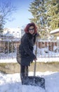 Woman shoveling snow off sidewalk Royalty Free Stock Photo