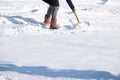 Woman shovelling snow to clear her driveway after winter storm