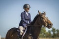 Woman riding a bay hunter jumper gelding