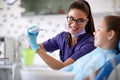 Woman show how to properly brush teeth on jaw model