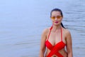 Woman show pretty breast with red bikini on beach