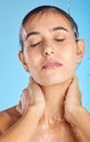 Woman, shower water and face of a calm model ready for morning skincare and wellness. Blue background, studio and