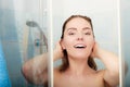 Woman showering in shower cabin cubicle.