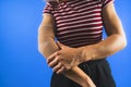woman showing a bandage on her elbow over a blue background Royalty Free Stock Photo
