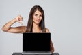 Woman showing blank black laptop computer screen