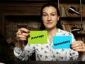 Woman showing blank green and blue business cards with written text Average Inventory