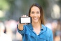 Woman showing a blank horizontal phone screen